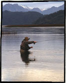 Fly fishing for trout with the Andes Mountains in the background. Photograph by Adrian Dufflocq, Cumilahue Fly Fishing Lodge. 